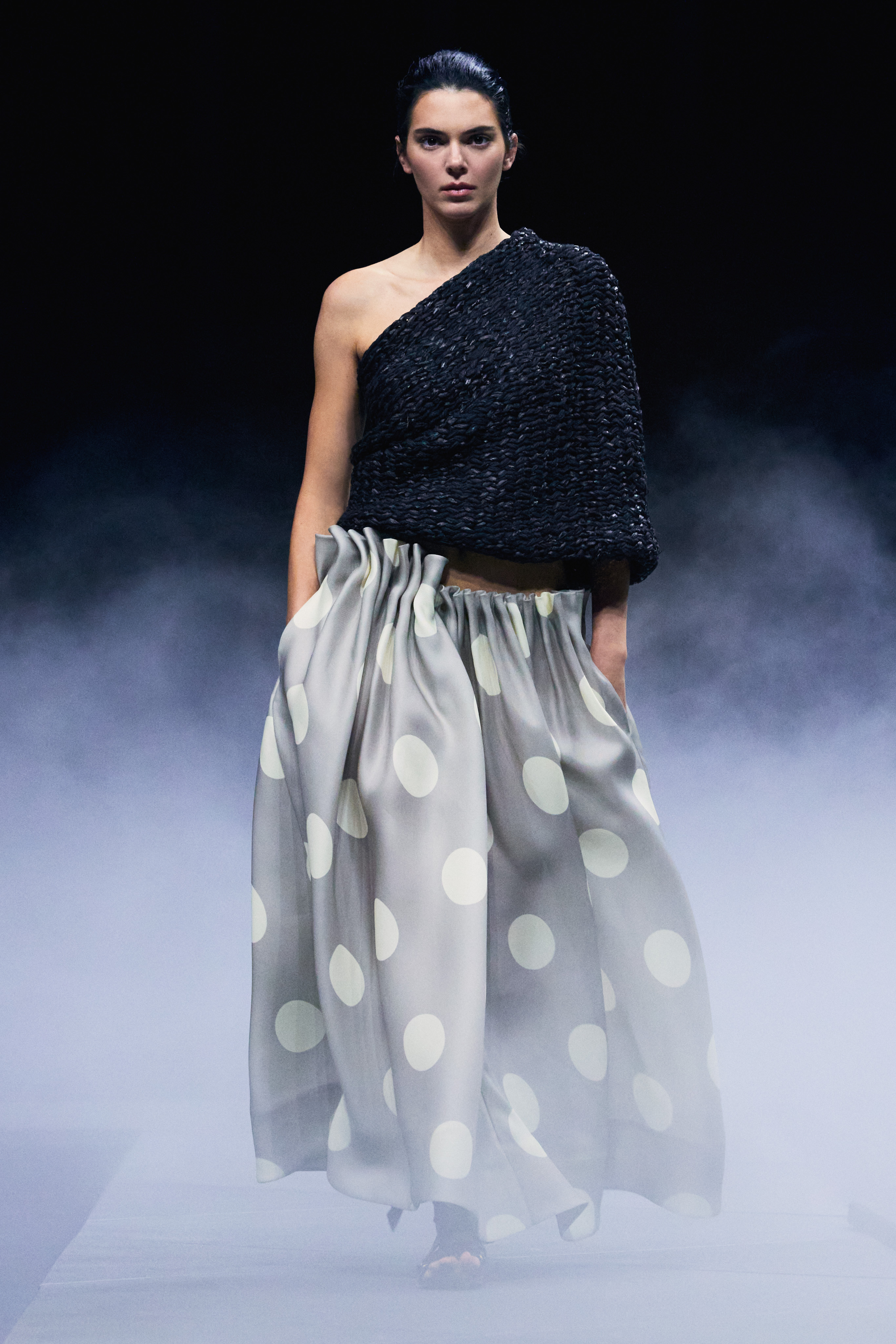 Kendall Jenner in a polka dot skirt and gray sweater in the khaite show