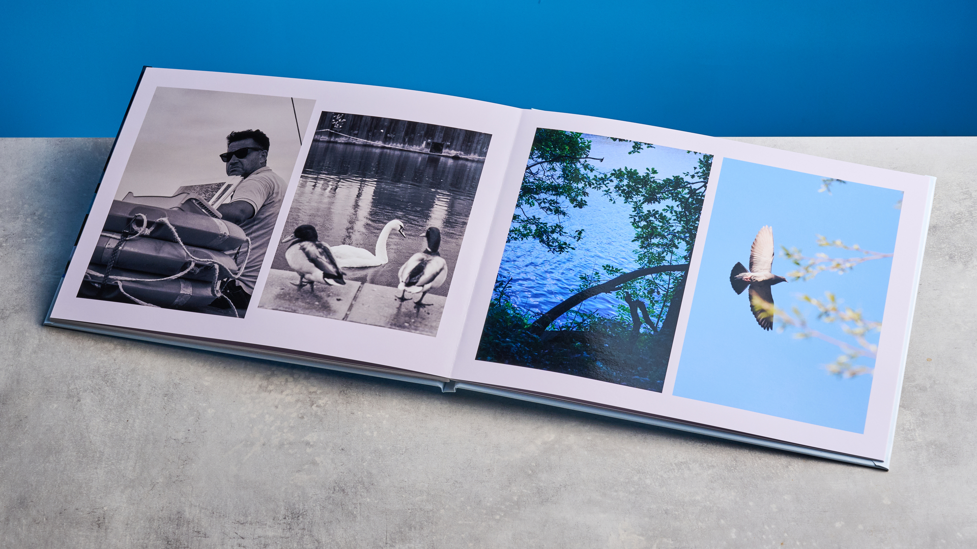 Popsa photo book photographed in front of a blue background