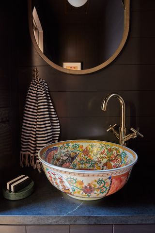 Dark powder room with patterned sink