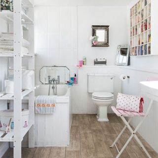 bathroom with white walls and wooden flooring