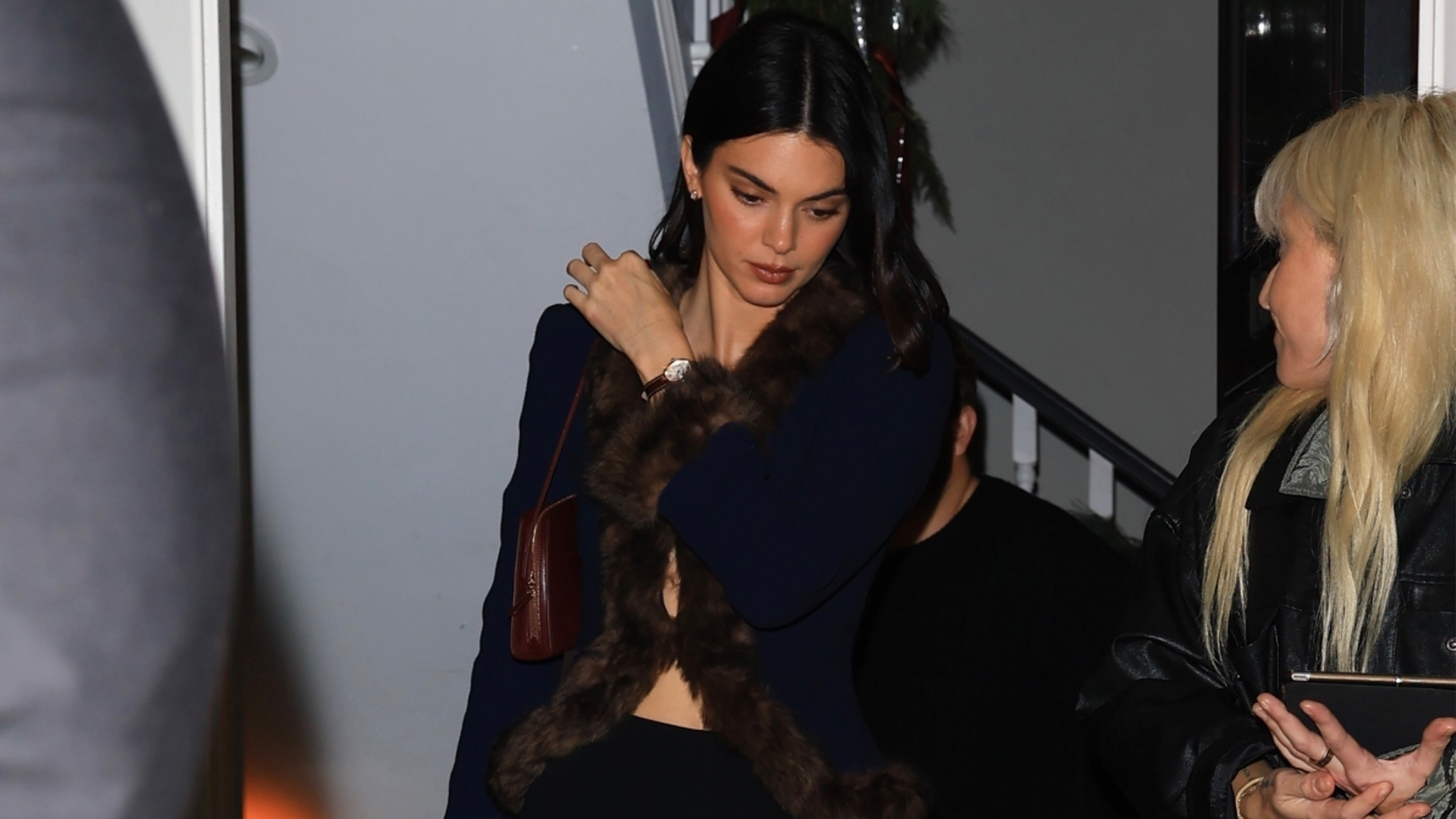 kendall jenner wears a fur-trimmed sweater and leggings.