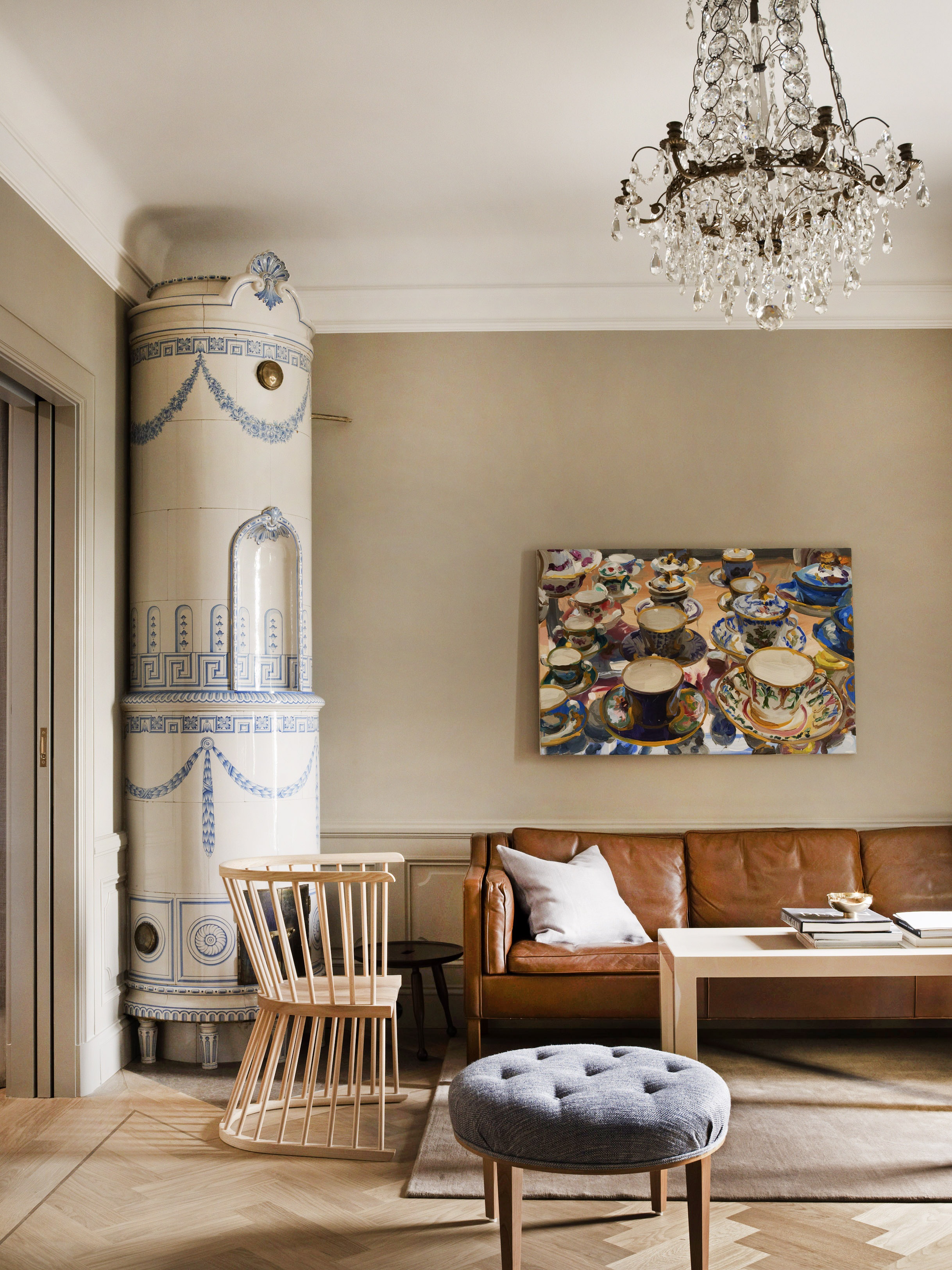 A quirkily decorated hotel room blends traditional accents like crystal chandeliers and handpainted ceramic cabinets with modern elements like leathery couches and Scandinavian furniture.