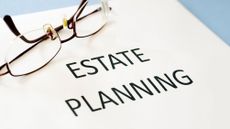 Estate planning documents on a desk and a pair of glasses sitting to the side