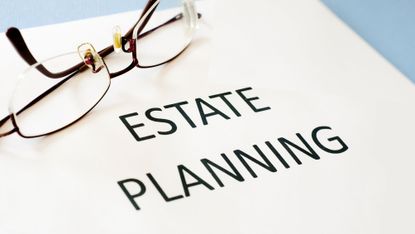 Estate planning documents on a desk and a pair of glasses sitting to the side