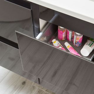 storage drawers in bathroom grey flooring and products inside drawer