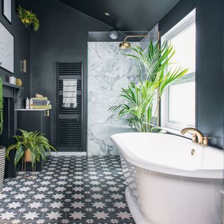 Dark painted bathroom with bathtub and patterned flooring