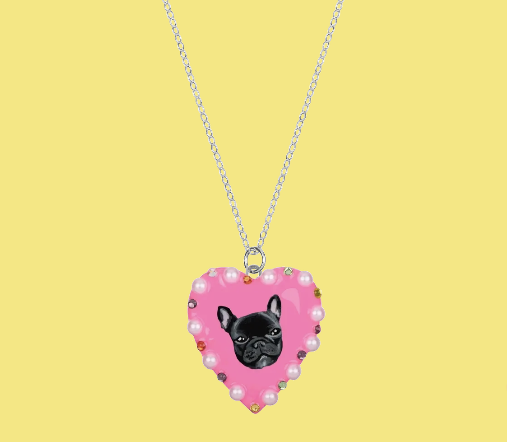 A heart locket with a dog painted on it