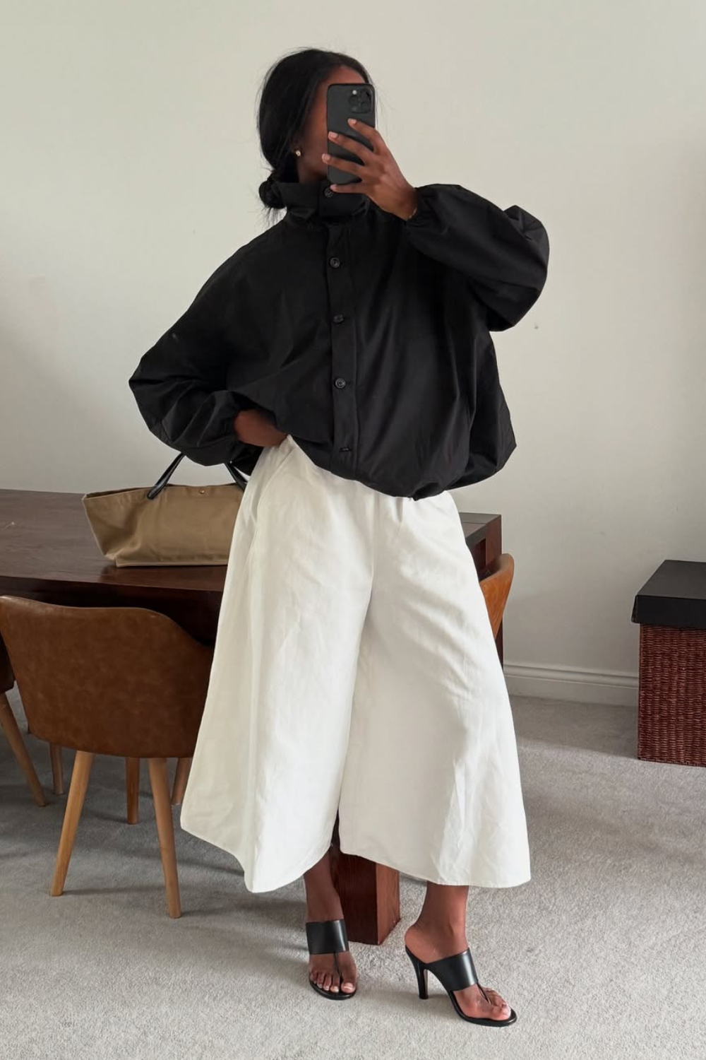 @nlmarilyn wears black bomber jacket, white culottes, black heeled sandals