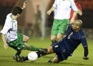 Ireland defender Alex Bruce makes a challenge on Scotland's Chris Iwelumo in a game in 2007.