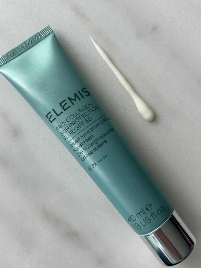 Elemis SPF bottle on a marble table