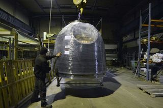 The Soyuz TMA-18M capsule, shrink wrapped for transport, arrives at the Danmarks Tekniske Museum in Denmark.