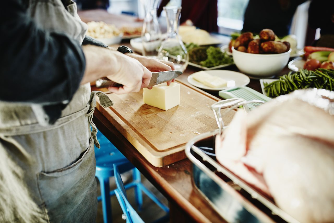 Chef cutting butter on cutting board