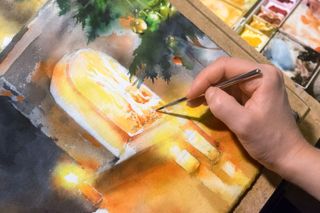 hand adding brushwork to watercolour fire