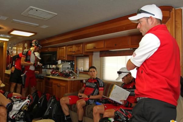 Director Sportif Mike Sayers runs through the day&rsquo;s plans with the team shortly before sign-in. Known as a tough and competitive rider, Sayers adopts a similar approach as DS.