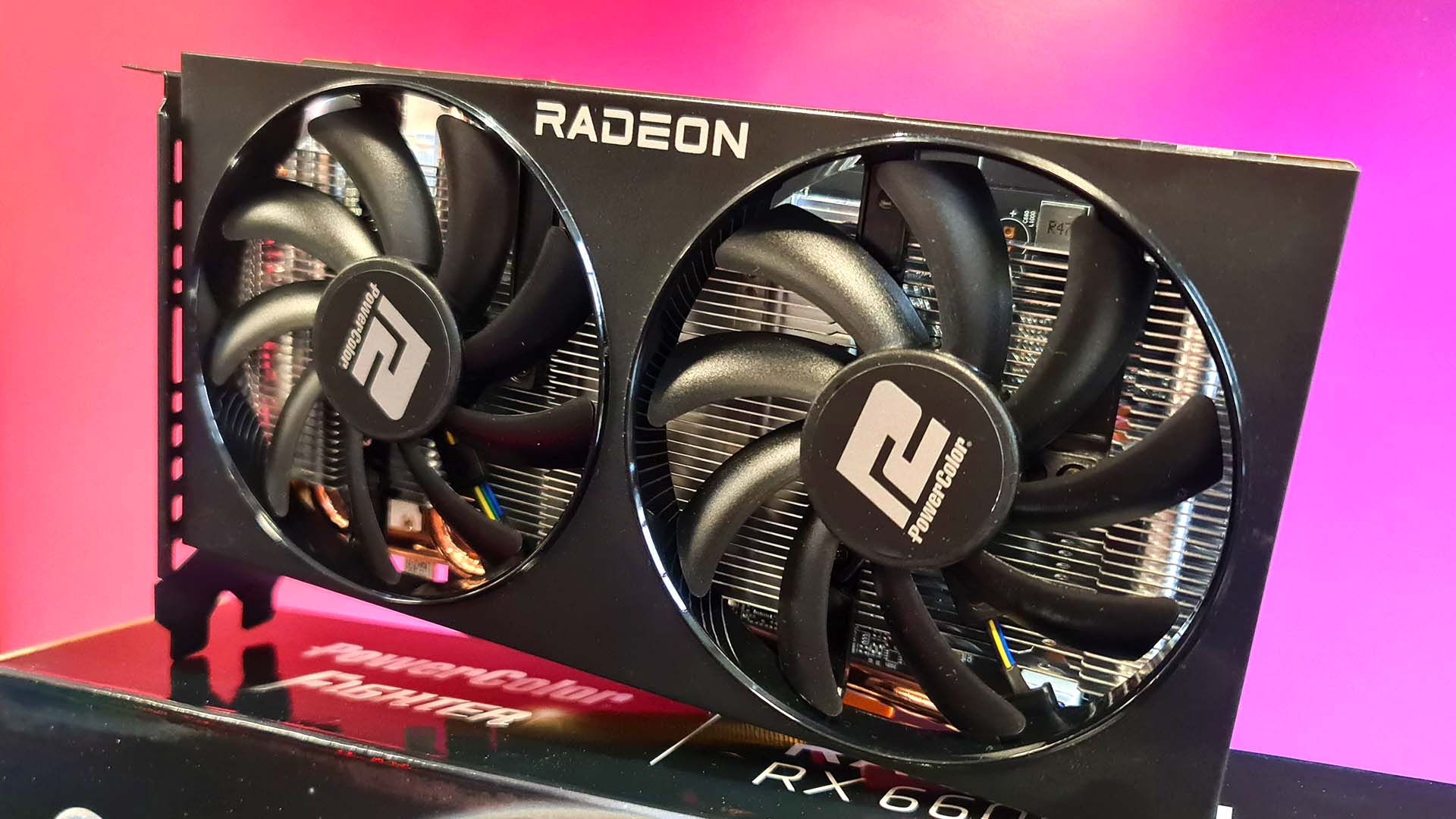 AMD Radeon RX 6600 graphics card on colourful background.