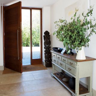 hallway with white wall and plant in vase