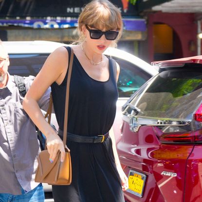 Taylor Swift spotted in New York wearing a long back dress with belt and sandals