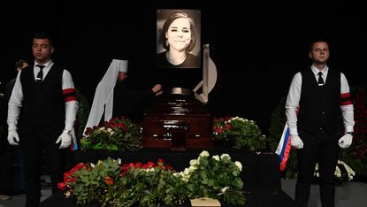 A potrait of Daria Dugina is displayed near her coffin during a farewell ceremony