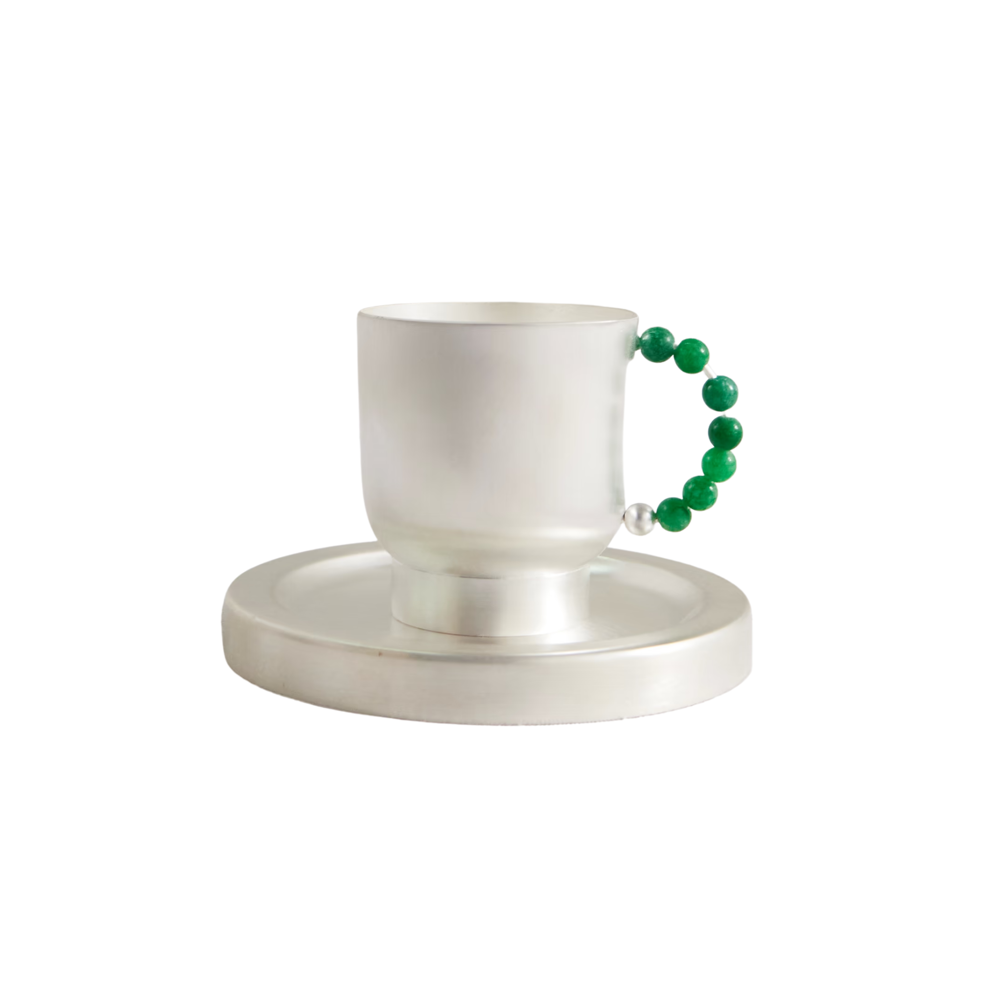 silver teacup and saucer set with a green beaded handle