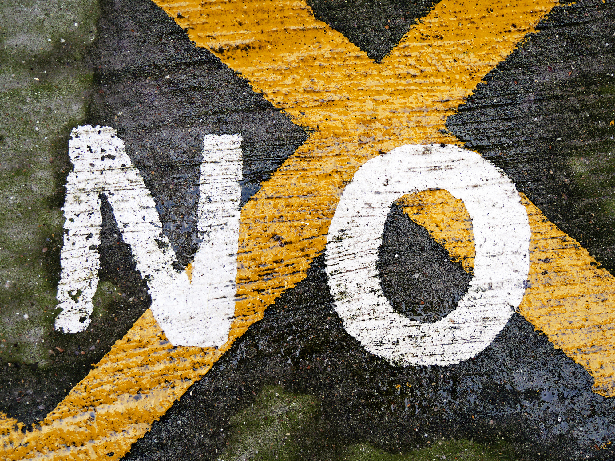 The word No painted on a street. Close-up of a road marking (No Parking) in London,