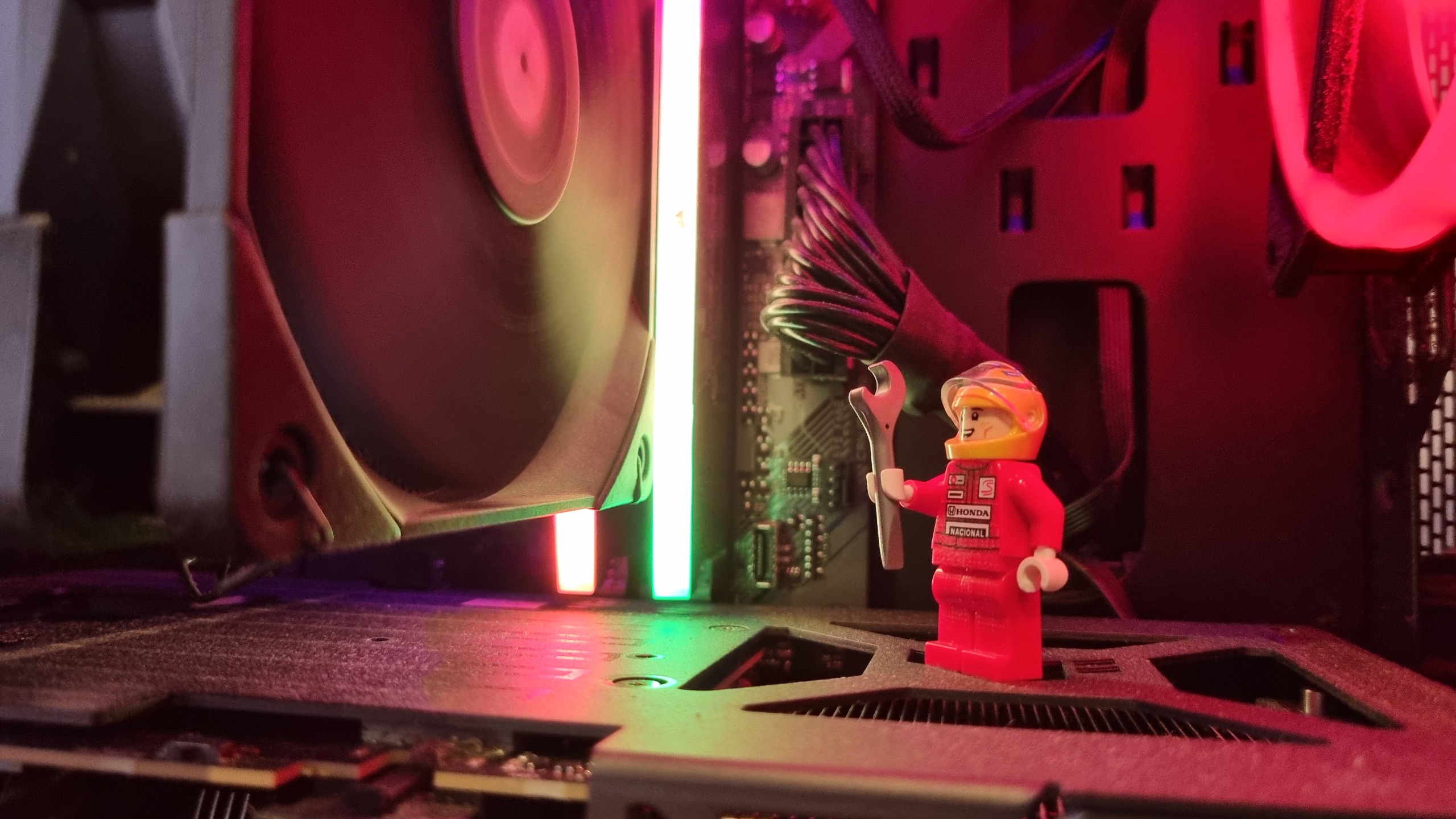 A Lego minifig of Ayrton Senna, inside a gaming PC standing on a graphics card