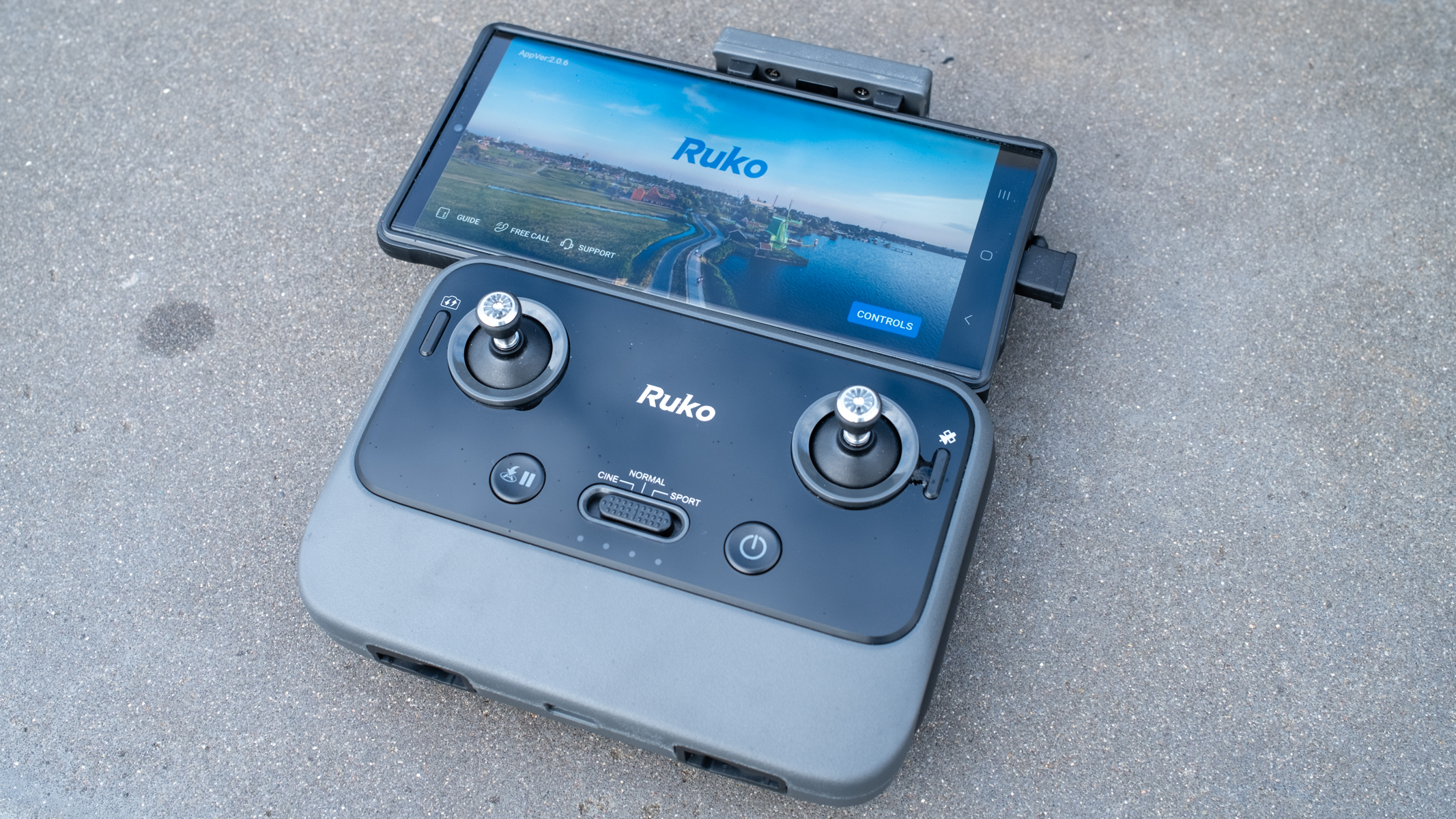 Ruko U11MINI drone controller with a phone attached.