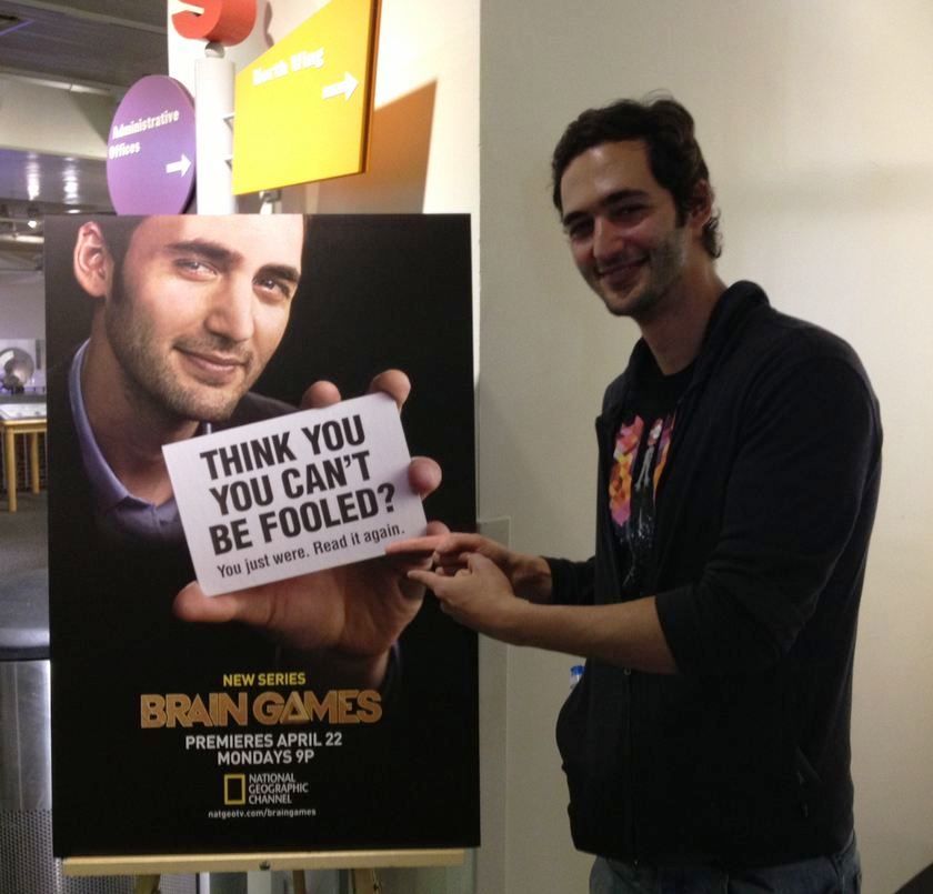 Jason Silva, the host of National Geographic Channel&#039;s show &quot;Brain Games,&quot; pointing to his poster. It may trick you. 