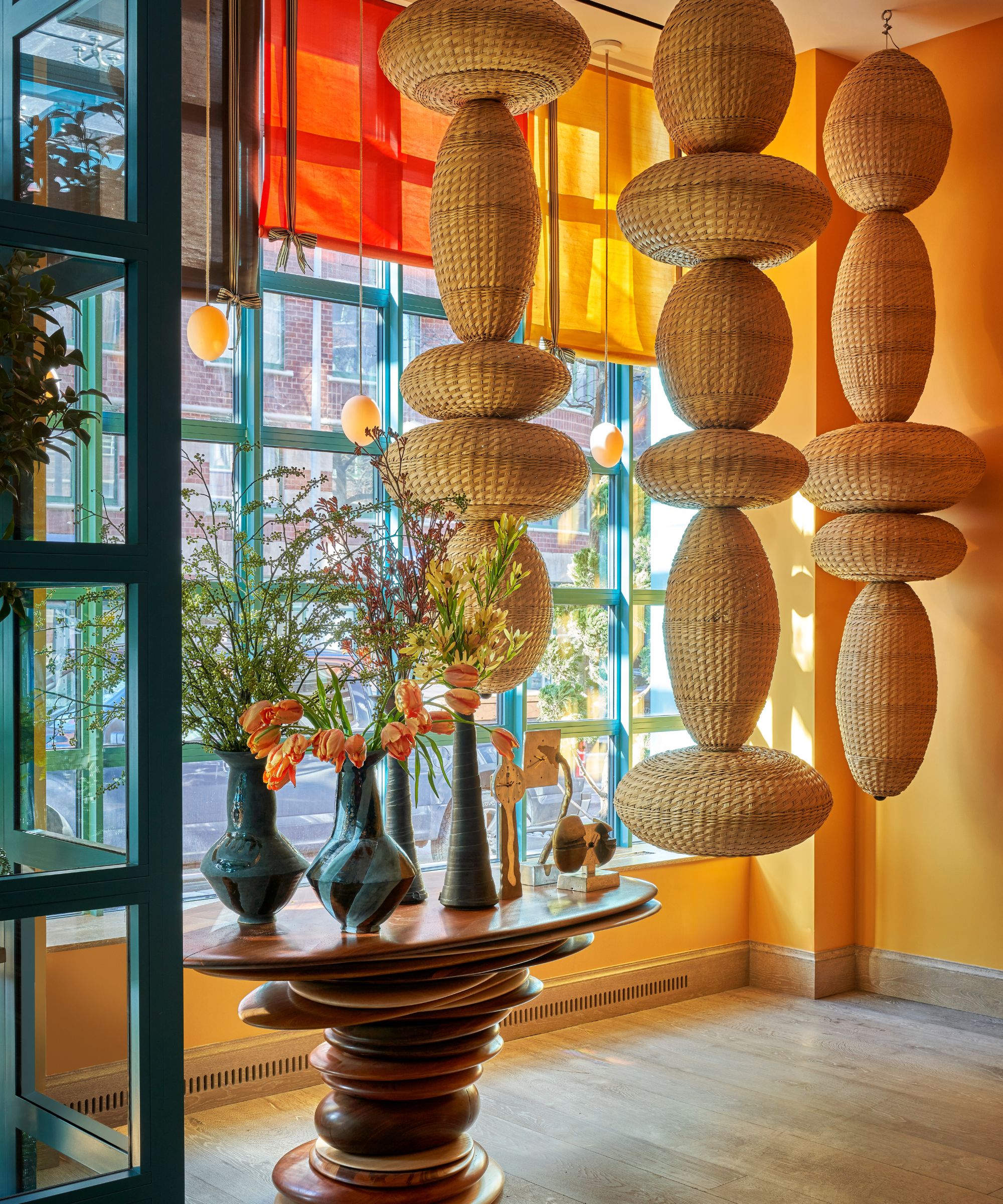 Hanging artwork in a window of a yellow room