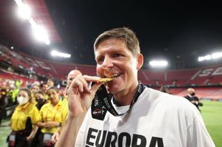 Oliver Glasner, Head Coach of Eintracht Frankfurt celebrates by biting their UEFA Europa League winners medal following victory in the UEFA Europa League final match between Eintracht Frankfurt and Rangers FC at Estadio Ramon Sanchez Pizjuan on May 18, 2022 in Seville, Spain.