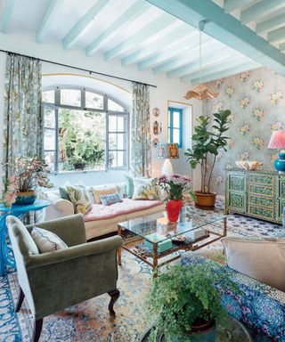 Eclectic living room with houseplants and blue painted ceiling