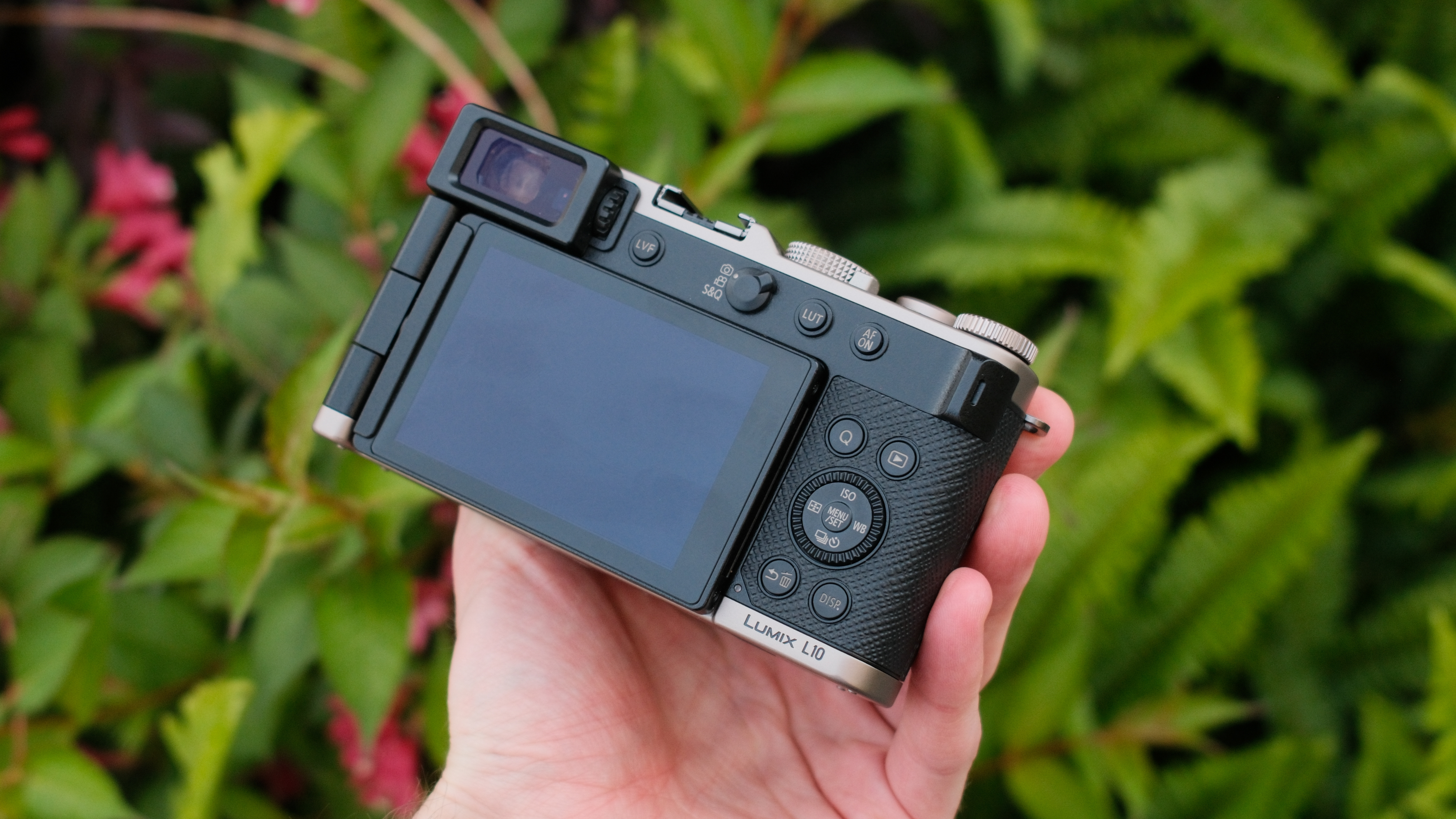 Close-up of the Lumix L10 top plate, lens barrel, and control dials.