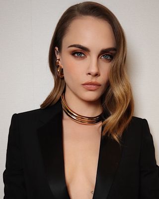 Cara Delevingne wearing a peach lipstick