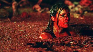 a women covered in blood underground in the movie the descent