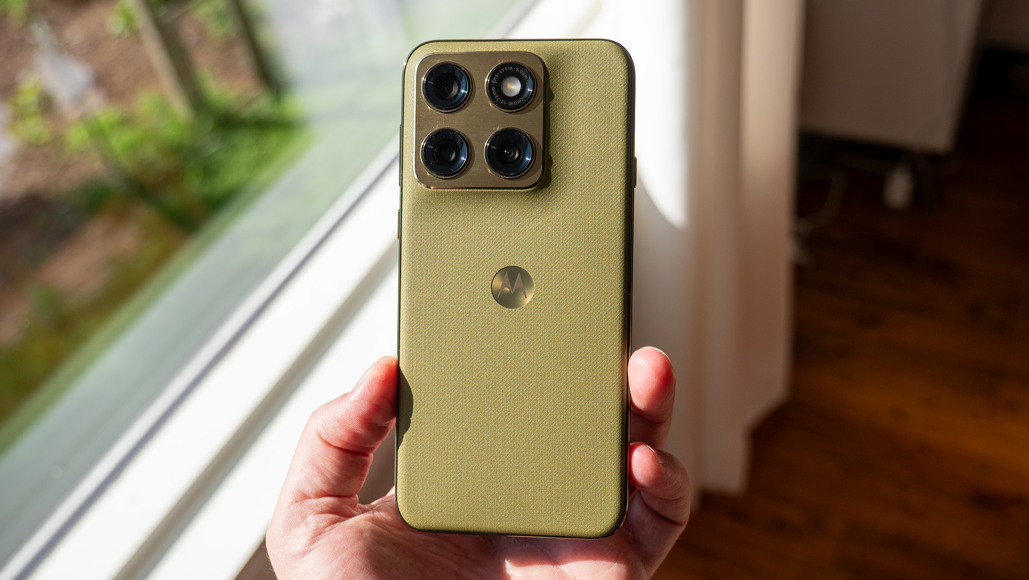 The back of the olive green Motorola Edge 2026 with its metal camera island