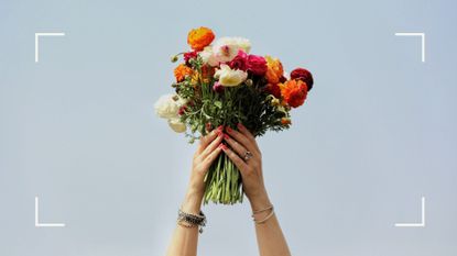 Woman's hands holding up a bouquet of flowers, representing gifts received in a rebound relationship