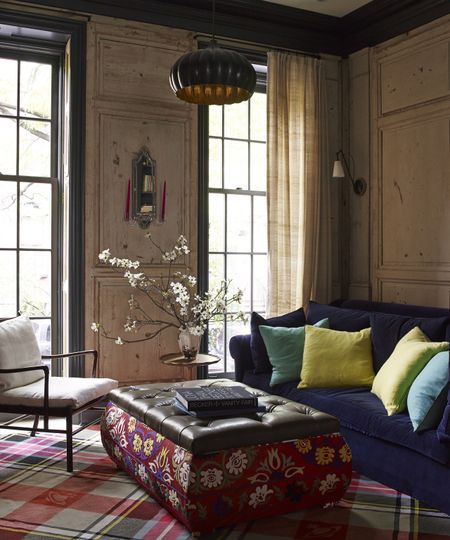 living room with boiserie panels and patterned ottoman