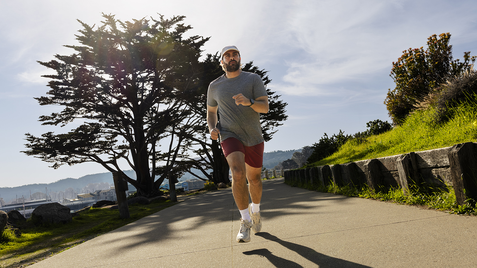 Runner exercising on a pavement wearing a Garmin watch