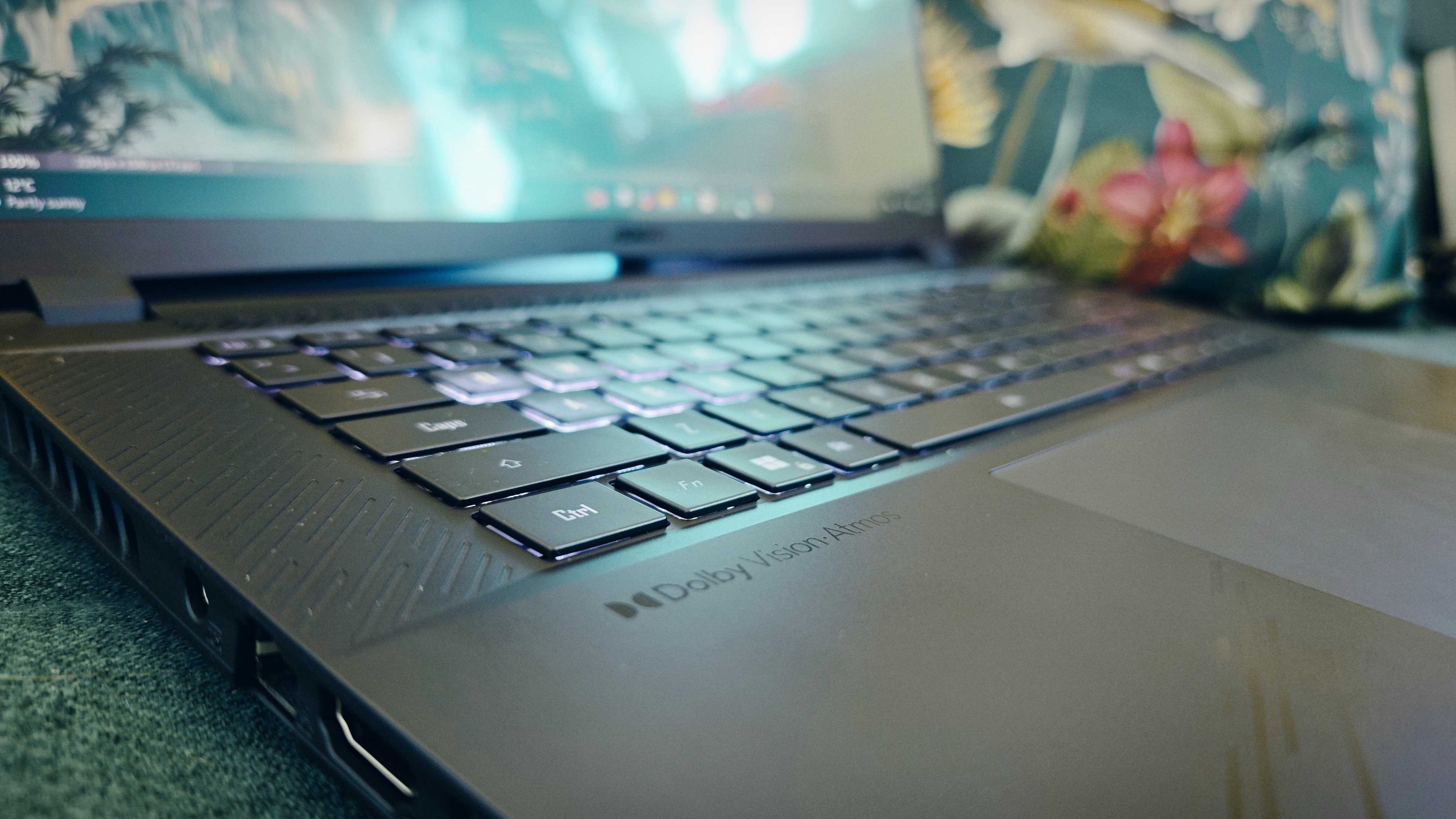 A Gigabyte Aorus Master 16 laptop on a green sofa