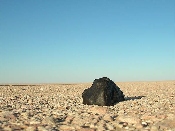 A chrondite meteorite in situ in Rub&#039; al Khali, Saudi Arabia.