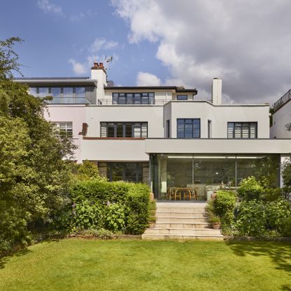 Exterior of extended Bauhaus property in southwest london with trees and shrubs