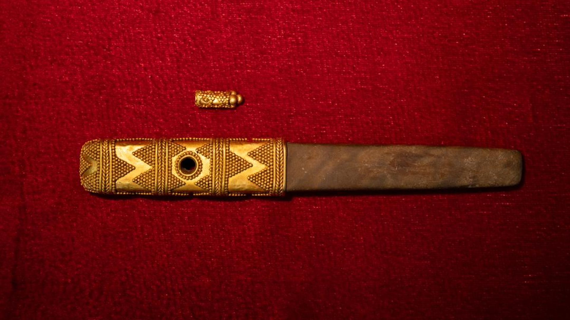 a dagger with a gold handle