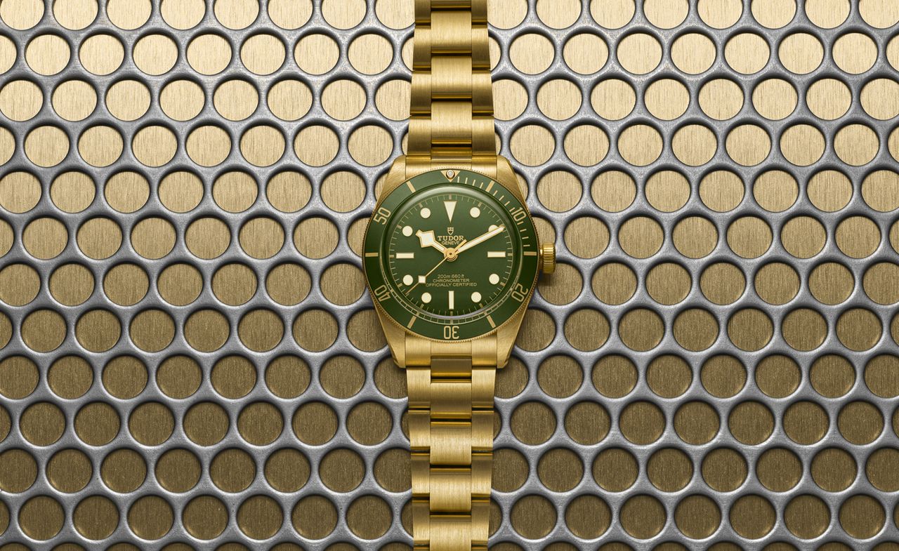 Tudor watch on mesh background, one of our pick of gold watches