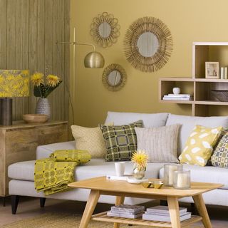 living room with wooden shelves and sofa with cushions