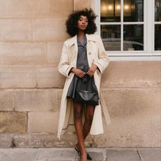 French clothing styles UK: @emmanuellek wears a trench coat and mini skirt