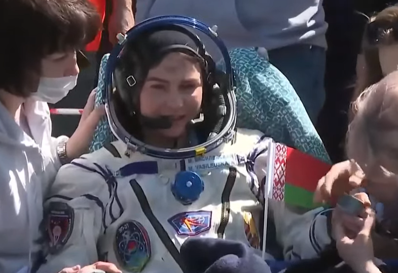 Vasilevskaya has a beaming smile after being lifted from the Soyuz capsule that carried her back to Earth