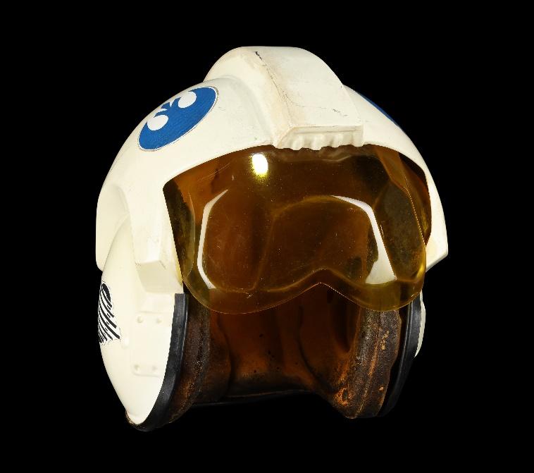 A white space helmet movie prop with a blue insignia
