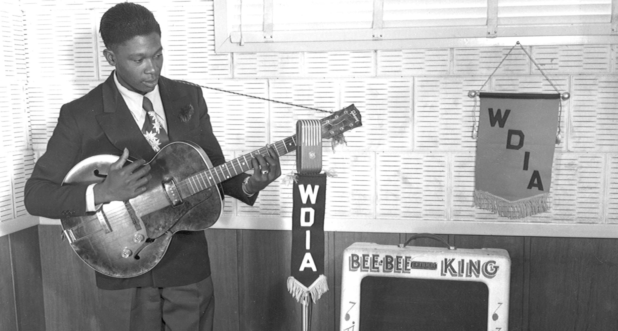 A young B.B. King already makes a play for the airwaves as he performs for WDIA. His name is written "Bee-bee King" on his amplifier.