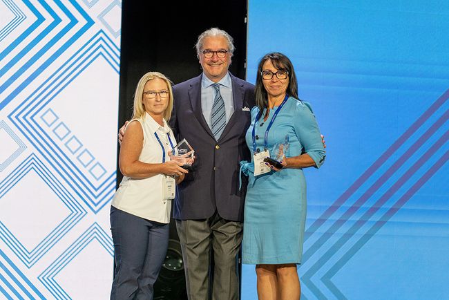 NCTC CEO Lou Borrelli on the Independent Show&rsquo;s stage with the NCTC Employee of the Year award winners, Nisha Gowin (l.) and Barb Littrell.