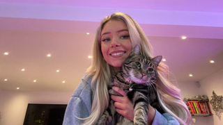 Megan holding her cat Nala and smiling