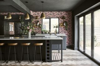 kitchen island with seating and floral wallpaper feature wall